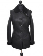 Load image into Gallery viewer, Black long Nappa Merino sheepskin fur fitted jacket with buttons opening, regular collar, and pockets at the front displayed on a mannequin.