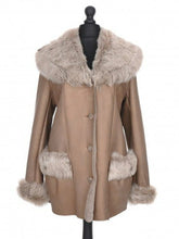 Load image into Gallery viewer, A brown sheepskin coat with a fur collar and cuffs, featuring a loose silhouette and button fastening. The coat is displayed on a mannequin.