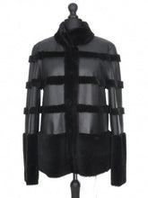 Load image into Gallery viewer, A black reversible Nappa merino sheepskin fur jacket with a stand-up collar and press-stud fastening, adjustable sleeve length displayed on a mannequin.
