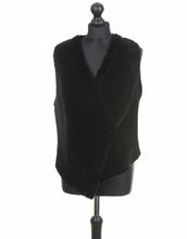 Load image into Gallery viewer, Black suede merino sheepskin reversible vest with a fitted silhouette and press studs at the front, displayed on a mannequin.