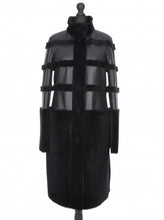 Load image into Gallery viewer, Black Nappa knee-length merino sheepskin fur coat, displayed on a mannequin, with visible press-studs fastening and adjustable sleeves.