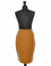 Load image into Gallery viewer, Camel color, midi-length, sheep leather skirt with a fitted silhouette, invisible zipper and vent at the back, displayed on a black mannequin.