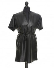Load image into Gallery viewer, A black leather mini skirt-blouse-tunic displayed on a mannequin, featuring a V-neckline, short sleeves, and a belt.