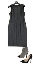 Load image into Gallery viewer, Black sleeveless dress with gray ankle boots and black high heels on a white background