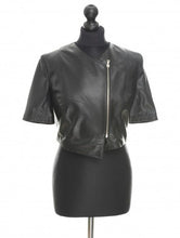 Load image into Gallery viewer, Black sheep leather mini jacket with short sleeves and a front zip, displayed on a mannequin.