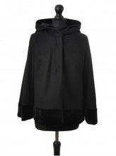 Load image into Gallery viewer, Black hooded wool cloak with velour trimming, displayed on a mannequin, with press-studs fastening.
