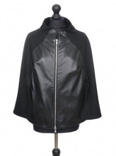 Load image into Gallery viewer, Black textile cloak with sheep leather details and a two-way zip fastening, displayed on a mannequin.