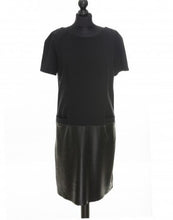 Load image into Gallery viewer, A black color knitted fabric midi length dress with perforated leather detail and pocket imitation in front, short sleeves, and an invisible zipper at the back.