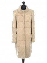 Load image into Gallery viewer, Beige long sheepskin fur coat with decorative textile inserts, featuring a stand collar, front pockets, and lining inside.