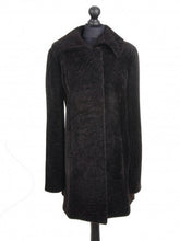 Load image into Gallery viewer, Dark chocolate brown knee length sheepskin fur coat displayed on a mannequin with a regular collar, front pockets, and lining visible.