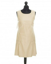 Load image into Gallery viewer, A light beige color, fitted silhouette, midi-length sleeveless dress with round neckline, displayed on a mannequin.