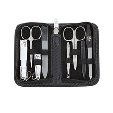 Load image into Gallery viewer, A black nail care kit case with various nail tools including scissors, clippers, a file, and a pusher. The tools are bright nickel plated and the case is made from PU leather with a geometric pattern.