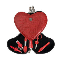 Load image into Gallery viewer, A heart-shaped nail care kit with red PU leather and metal tools including scissors, clippers, tweezers, a nail file, and a nail pusher/cleaner, presented in a black case with a Croco pattern.
