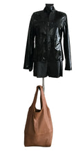 Load image into Gallery viewer, Black leather jacket and brown leather bag on a mannequin against a white background