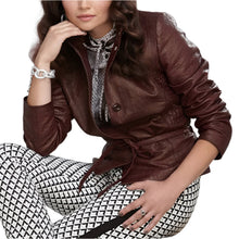 Load image into Gallery viewer, Woman wearing a brown leather jacket and patterned pants against a blurred background