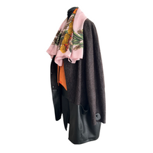 Load image into Gallery viewer, A brown wool cocoon style midi length cardigan with leather trim and press-studs fastening, lined inside, displayed on a mannequin with a pink floral scarf and an orange jacket.