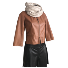 Load image into Gallery viewer, A camel color short leather jacket with an ostrich pattern effect, featuring a round neckline, zippered front, and 3/4 sleeves, displayed on a mannequin with a knitted grey scarf and black leather skirt.