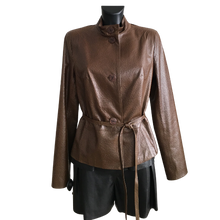 Load image into Gallery viewer, A brown sheep leather belted short jacket with buttons, displayed on a mannequin wearing a dark outfit.