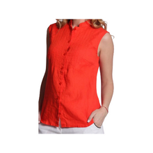 Load image into Gallery viewer, A woman wearing a blue, sleeveless, button-up linen blouse with decorative seams and a collar.