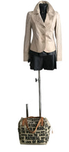Load image into Gallery viewer, Mannequin wearing a beige blazer and black skirt with a patterned bag on a white background