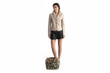 Load image into Gallery viewer, Mannequin wearing a beige blazer and black skirt with a patterned bag on a white background