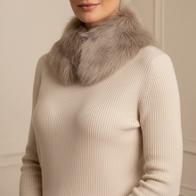 Įkelti nuotrauką į galerijos peržiūros programą, A woman wearing a cream ribbed knit sweater with a plush light gray-brown fur collar, posed against a neutral beige wall.
