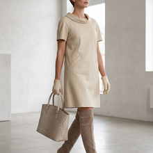 Load image into Gallery viewer, Vilniaus Kailiai beige dress with sleeveless design, featuring a stylish and comfortable fit, perfect for casual or formal wear.
