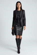 Load image into Gallery viewer, A black leather sleeveless dress displayed on a black mannequin against a light gray studio background.
