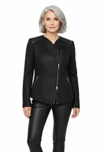 Load image into Gallery viewer, A woman with short gray hair wearing a black textured jacket with silver zippers and black faux-leather pants, photographed against a plain white studio background.
