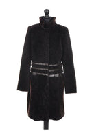 A dark chocolate brown knee length sheepskin fur coat with a regular collar and fur cuffs, displayed on a mannequin.