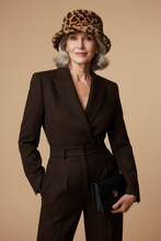 Load image into Gallery viewer, Woman wearing a brown suit and leopard print hat on a beige background
