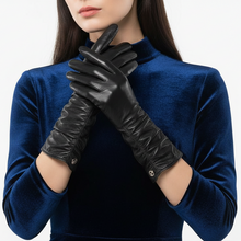 Įkelti nuotrauką į galerijos peržiūros programą, A model wearing long black leather gloves with a quilted texture and silver snap buttons, paired with a dark blue velvet top against a clean white background.

