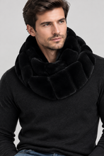 Įkelti nuotrauką į galerijos peržiūros programą, A close-up of a woman wearing a plush black infinity scarf with a textured, quilted panel design over a white ribbed knit top.

