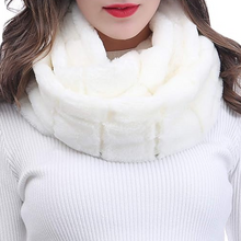 Įkelti nuotrauką į galerijos peržiūros programą, A woman with long brown hair wearing a thick, plush white faux fur infinity scarf and a white ribbed knit sweater, set against a plain white background.
