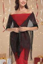 Load image into Gallery viewer, Woman wearing a black and red patterned shawl with festive decorations in the background
