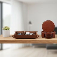 Brown leather tray and coasters on a wooden surface with a blurred background