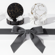 Marble-patterned coasters with a gray bow on a white background