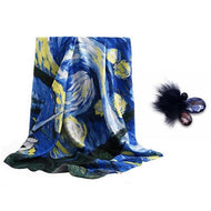 A blue and yellow floral silk scarf with a fur and stone brooch, displayed on a white background.