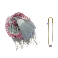 A tricolor striped unisex linen scarf with a golden metal pin featuring rhinestones, and a detached golden metal brooch.