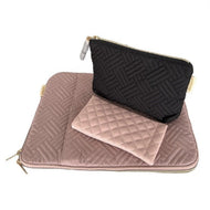 Two textile cosmetic bags, one in black and one in pink, with a quilted design and a faux leather trim.