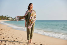 Įkelti nuotrauką į galerijos peržiūros programą, Woman standing on a beach with a floral scarf

