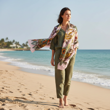 Įkelti nuotrauką į galerijos peržiūros programą, Woman standing on a beach wearing a floral scarf
