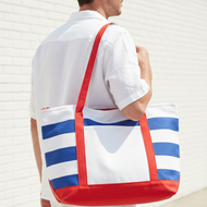 Person wearing a red, white, and blue striped tote bag against a light background