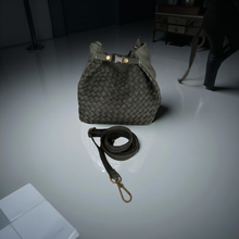 Load image into Gallery viewer, Gray woven handbag with matching strap on a reflective surface
