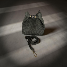 Load image into Gallery viewer, Green woven bag with a strap on a textured surface
