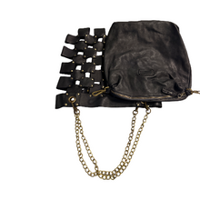 Load image into Gallery viewer, Black leather bag with cut-out design and gold chain on a white background
