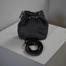 Load image into Gallery viewer, Black woven handbag with a strap on a white surface
