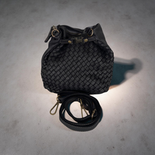 Load image into Gallery viewer, Black woven handbag with a strap on a gray surface
