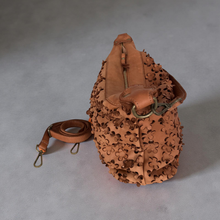 Load image into Gallery viewer, Brown leather bag with intricate cut-out design on a gray background

