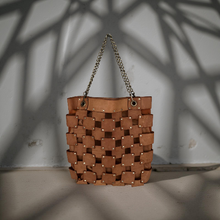 Load image into Gallery viewer, Brown woven handbag with chain handle on a neutral background
